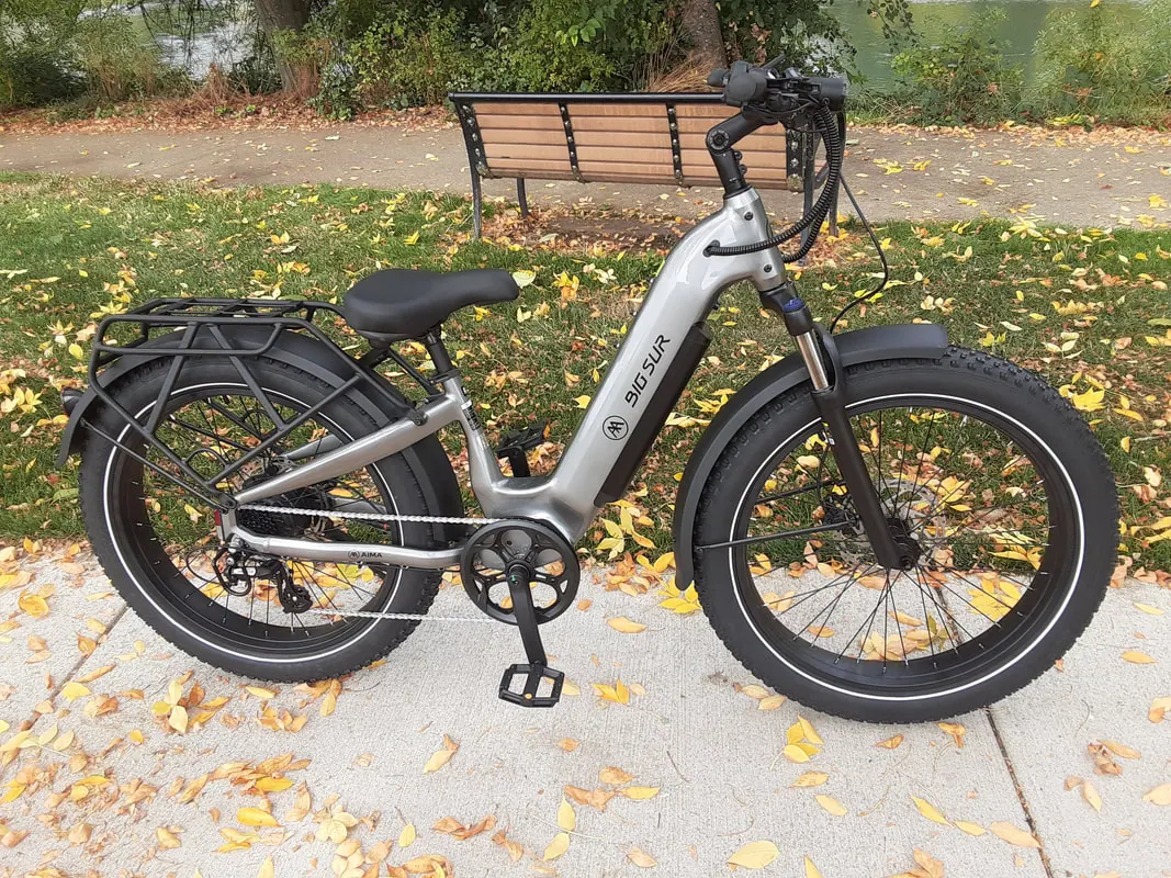 Aima Big Sur 2.0 fat-tire e-bike in silver, parked on an Albany park path